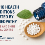 A wooden spoon filled with homeopathic pellets next to a blue bottle and green leaves.